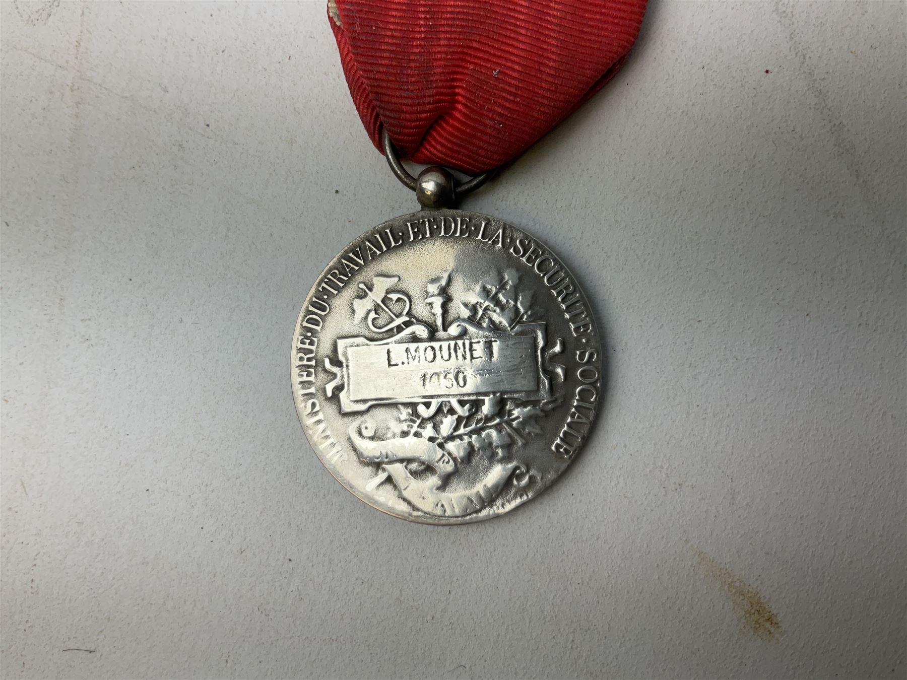 Five continental medals - WW1 Belgian Cross of Fire; WW1 French Croix De Guerre; French Croix De Combattant; French Republic Workers silver merit awarded to L. Mounet 1950; and boxed French Palmes Universitaires Officier d'Academie silver and enamel wreath (5)