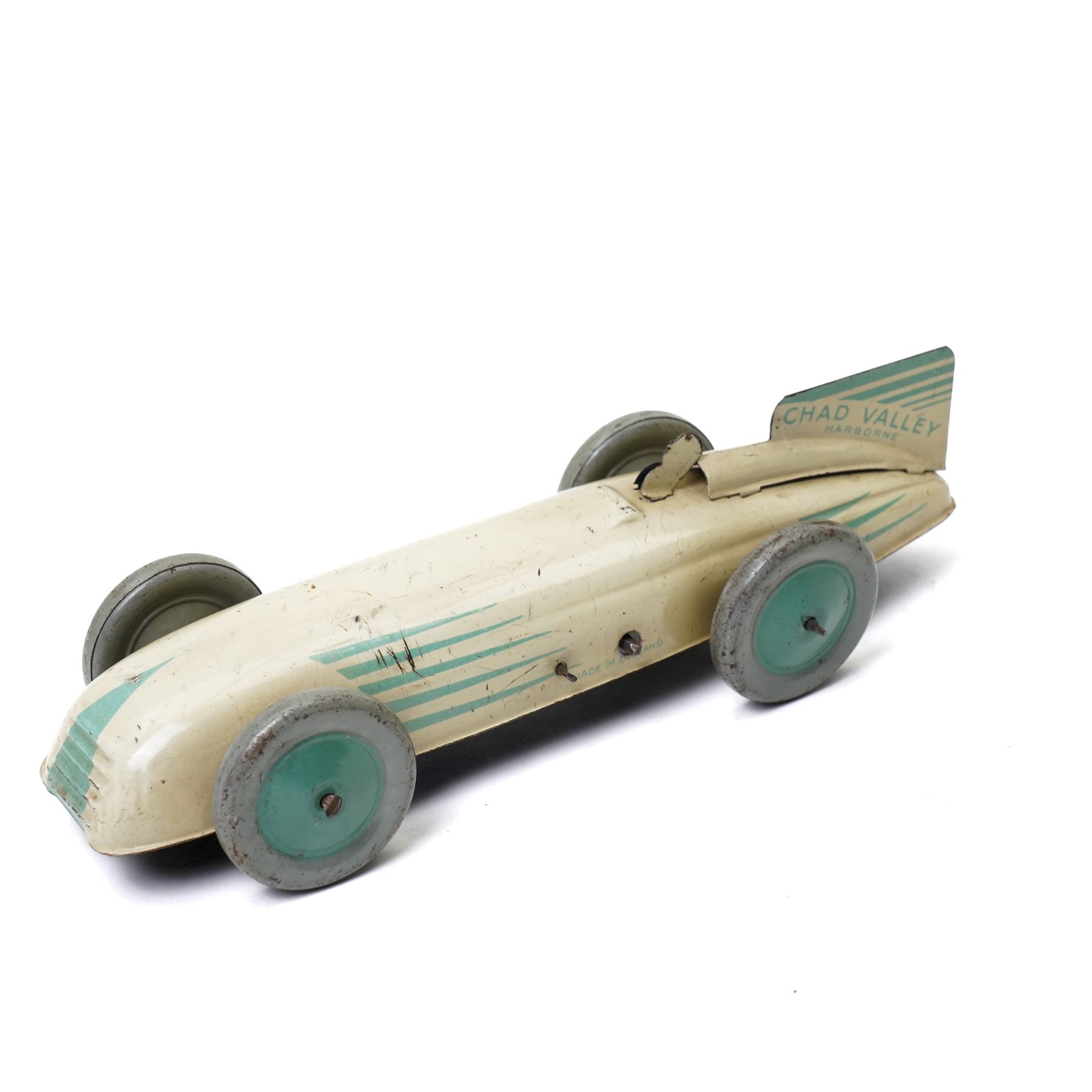 Chad Valley Harborne tin plate and clockwork racing car, cream and green with matching green hubs, length 20cm
