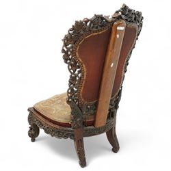 Late 19th century Anglo-Indian carved hardwood nursing chair, cartouche-shaped back, pierced fruit vine carved frame, gros-point tapestry upholstered seat, on carved scroll legs 