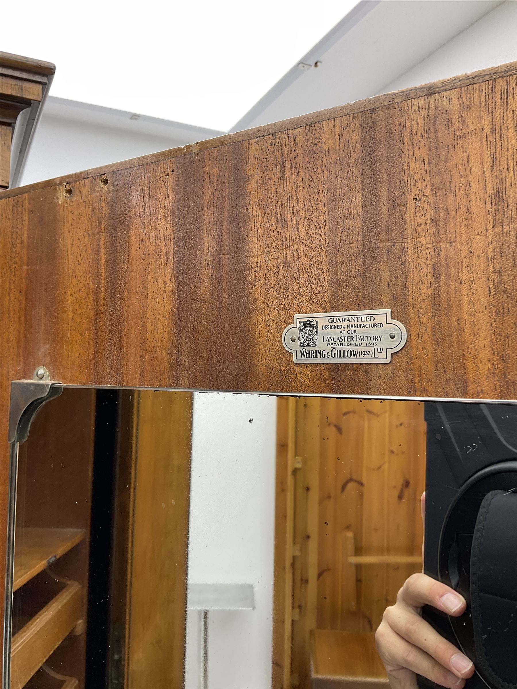 Waring and Gillow - early to mid 20th century figured walnut Gentleman’s wardrobe, two doors enclosing various compartment, mirror, drawers and hanging space, labelled 