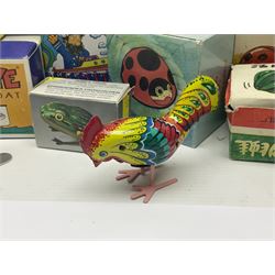 Twenty six tinplate models to include Ferris Wheel and Performing Circus Elephant, marked JW, further similar examples such as Duck on a Bike, Clown on Roller, Carousel; Popeye Tin Speedboat; Looney Tunes Wind Up Cars and Express Train; various international examples, MS107 Jumping Bambi, Pop Pop Boat, jumping frogs, pecking chickens etc; both boxed and loose