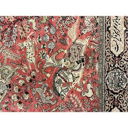 Fine Persian silk and cotton hunting rug, pink ground field depicting hunting scenes, trees and flowers, the border decorated with scrolls and script panel