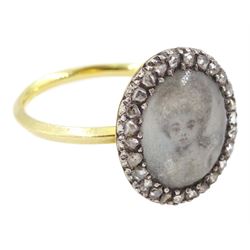 18th / 19th century gold and silver diamond portrait ring, set with an oval miniature of a woman on ivory, under glazed panel, with rose cut diamond surround and angular shank. This lot has been registered for sale under Section 10 of the APHA Ivory Act