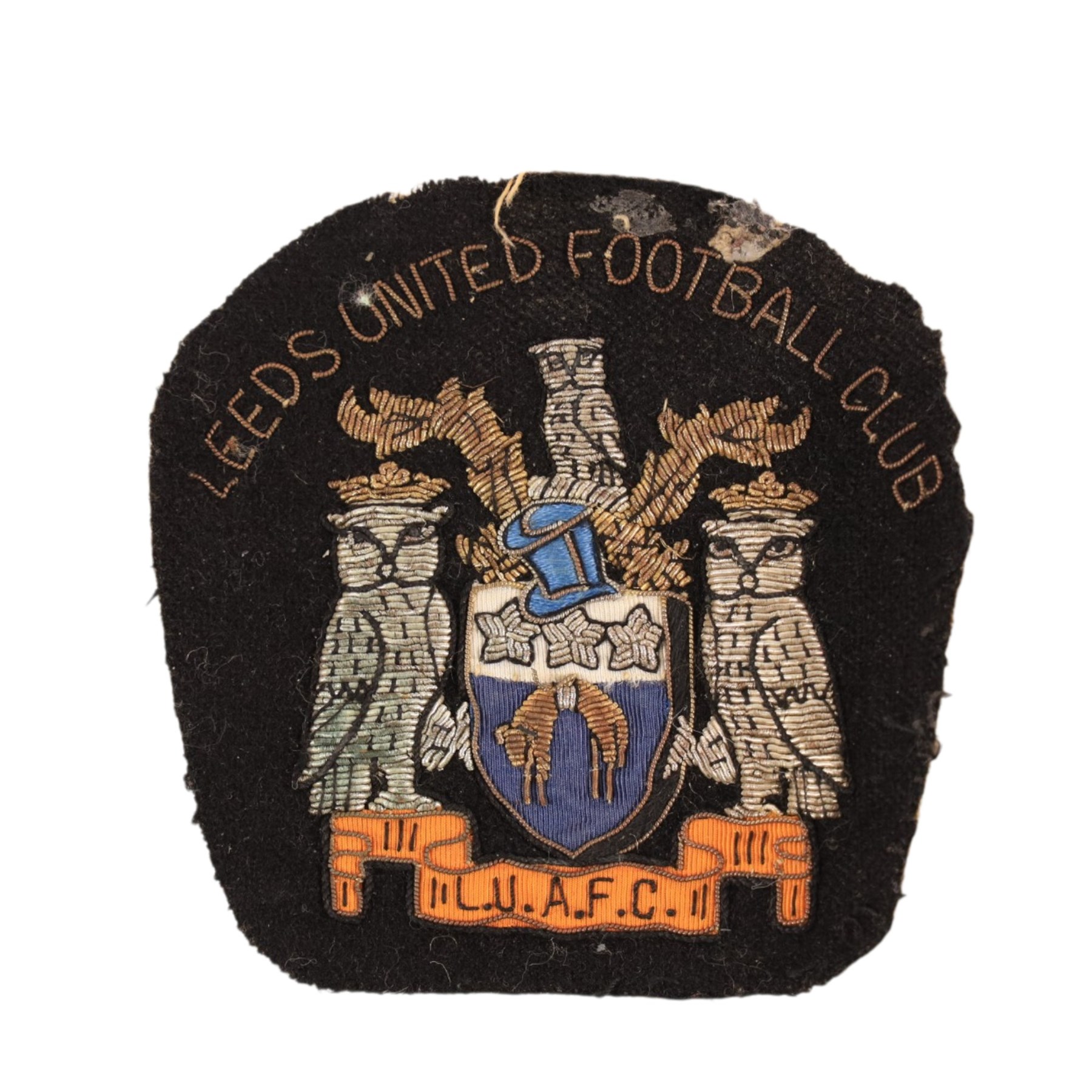 Collection of Leeds United enamel badges, including League Champions and League Winners examples, and a embroidered LUAFC patch