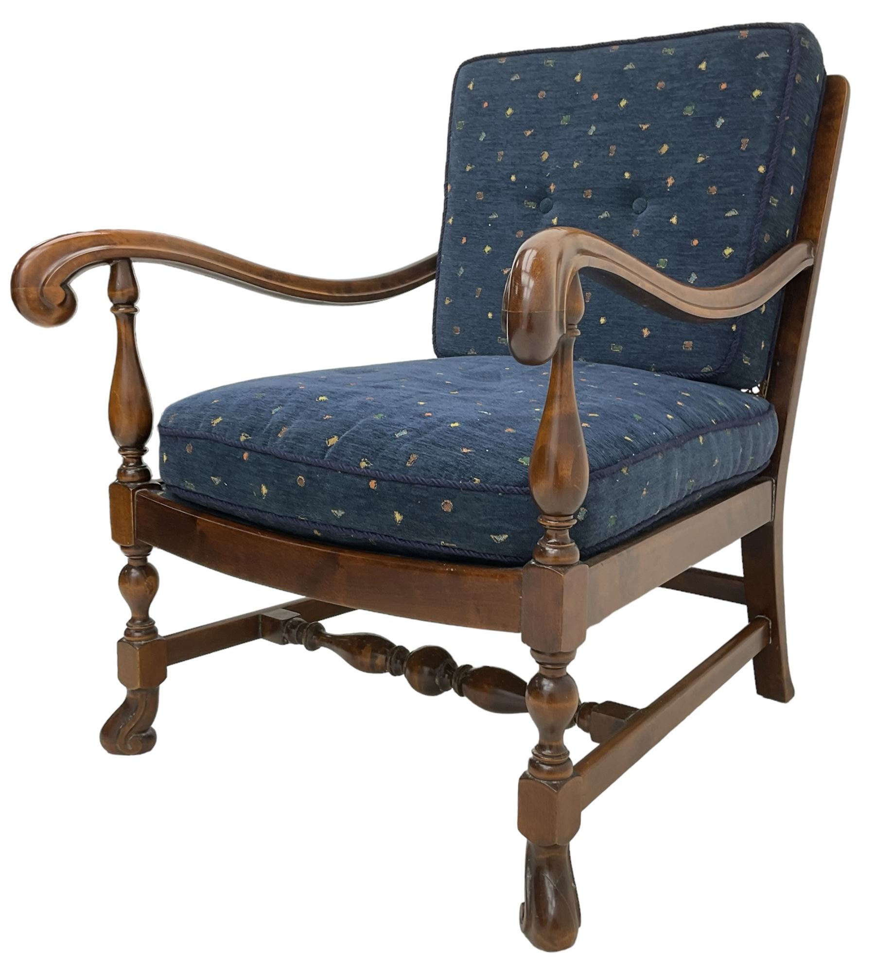 Early 20th century stained beech framed armchair, cane panel back over scrolled arm terminals, raised on turned supports united by turned H-stretcher, with patterned blue upholstered loose back and seat cushions
