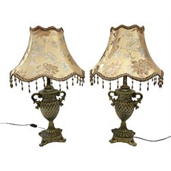 Pair bronzed amphora lamps with pineapple decoration, scroll handles and foliate base with scrolled feet together with pair peach ground shades and raised floral pattern H76cm (2)