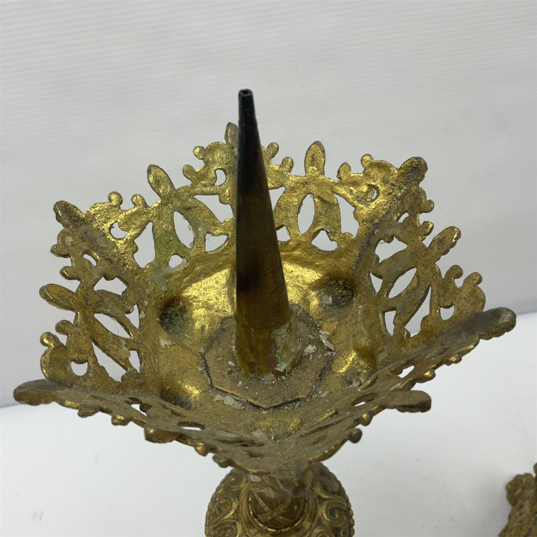 Pair of gilt metal pricket candlesticks, with applied decoration on knopt stems and triform bases, H47cm
