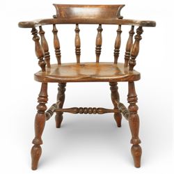 20th century captain’s oak smoker’s chair, with curved horseshoe back rail, turned spindle supports, shaped solid seat, turned legs united by stretchers