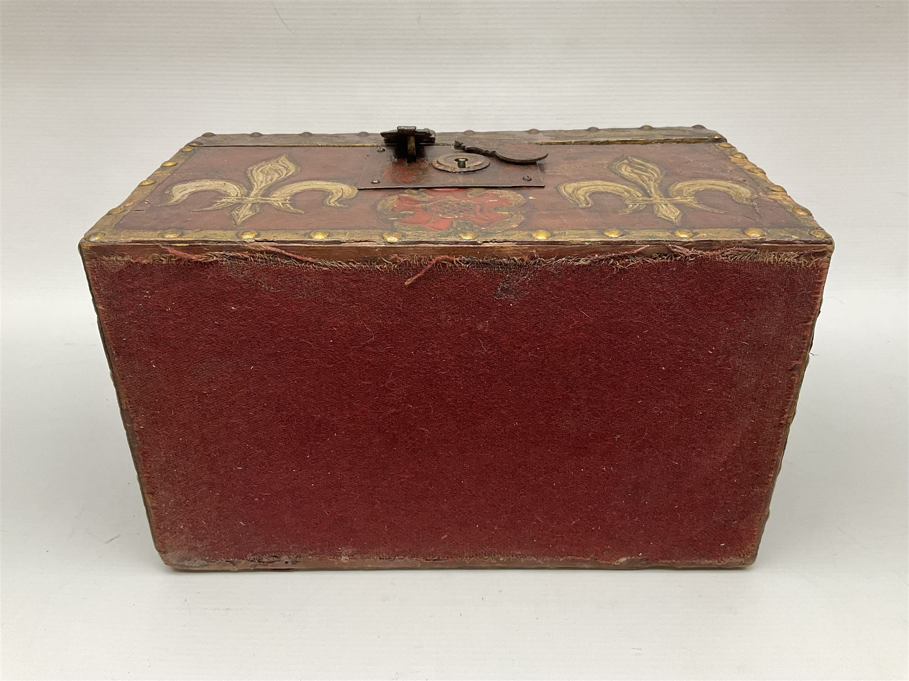 20th century box, decorated in faux leather with the royal coat of arms and GR 1719 to hinged cover, with fleur-de-lis, lion, crown and rose motifs throughout and studs to all edges, opening to reveal a purple velvet interior containing three removable wooden trays, H18.5cm