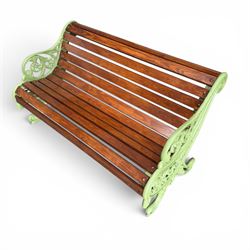 Pair of Victorian design cast iron and slatted wooden garden benches, the ornate pierced end supports of scrolled form, the pierced acanthus leaves interspersed with trailing flowerheads, with tassels to the front, raised on splayed feet, the supports in pale sage green painted finish