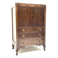 Early 20th century oak tallboy chest, double cupboard doors enclosing interior, above three long graduating drawers, raised on cabriole supports 