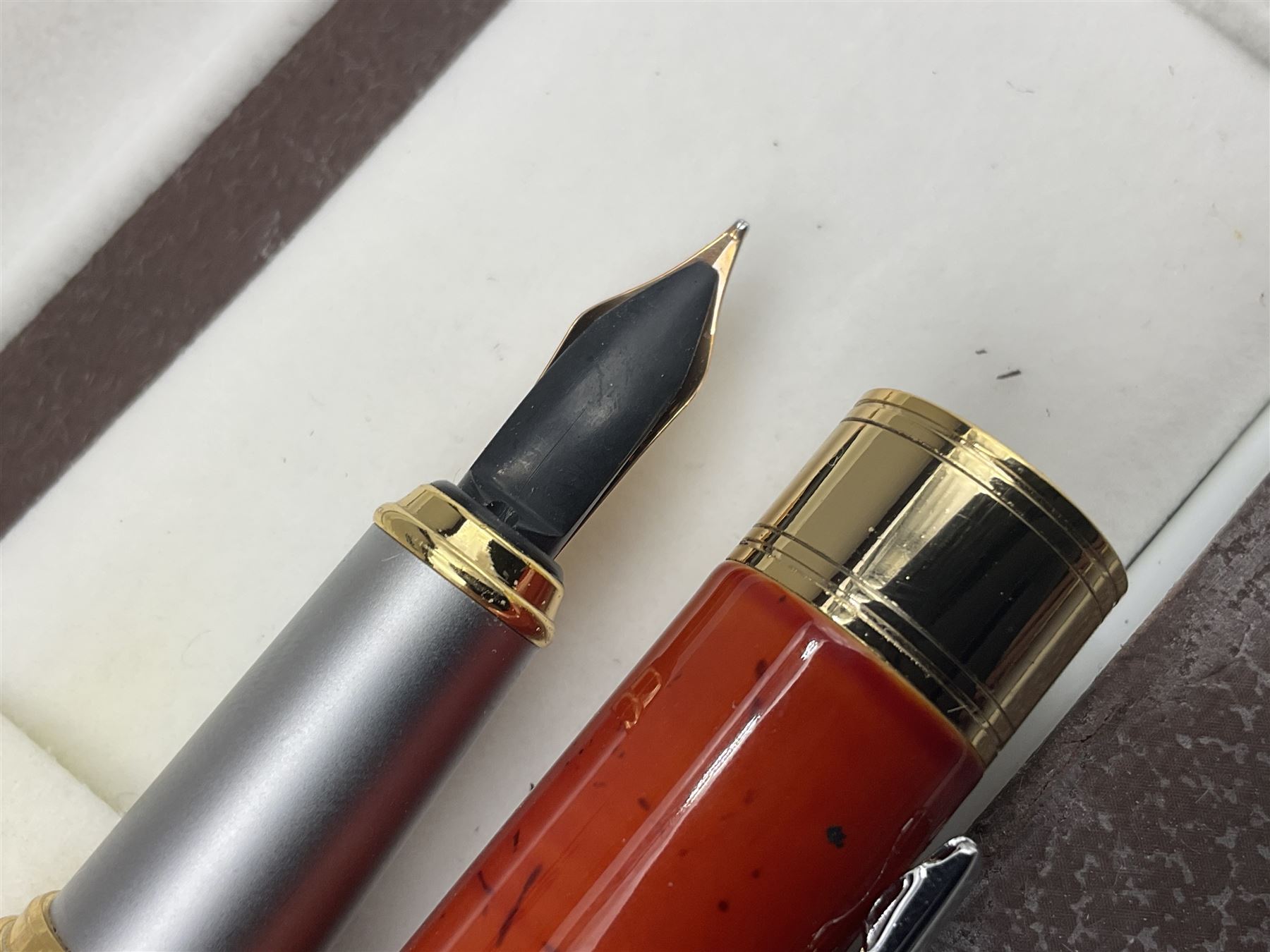 Circa 1930s Mentmore Auto Flow button fill fountain pen, the black barrel and cap with single narrow band and gold nib stamped Osmi Ridium 14ct, together with two gold nib fountain pens, each marked Huahong, the first stamped 14K 580, and second stamped 8K, both housed in Mentmore boxes (3)