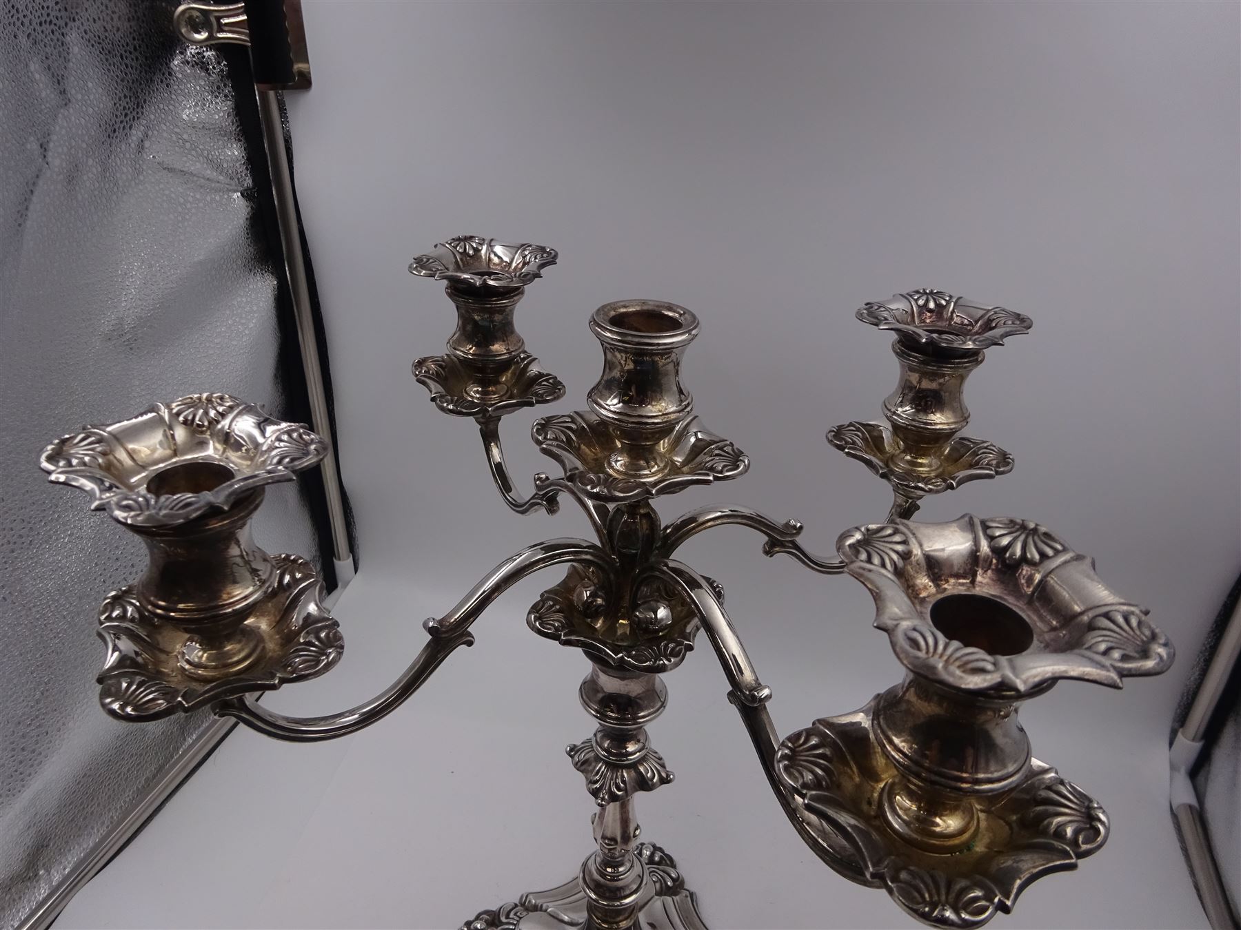 Modern silver five branch candelabra centrepiece, the four extending branches each with removable sconces, surrounding a central candle holder, upon a knopped stem and weighted stepped square foot, with anthemion to each corner, hallmarked Roberts & Belk, Sheffield 1984, H36cm 