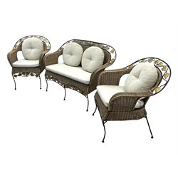 Late 20th century three-piece garden suite, wicker construction and wrought iron frame, decorated with cast metal leaf motifs, cream seat cushions and round back cushions