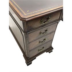 Large Georgian design mahogany twin pedestal partner's desk, moulded rectangular top with canted corners and inset leather writing surface, fitted with nine drawers and two cupboards, the pedestals with canted uprights decorated with blind fretwork, on ogee bracket feet