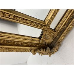 Gilt Rococo style mirror, arched top with central cartouche and oak leaf moulded pediment, floral and fruit moulded surround with segmented glass panels, bevelled central pane, c-scroll shell and acanthus leaf brackets