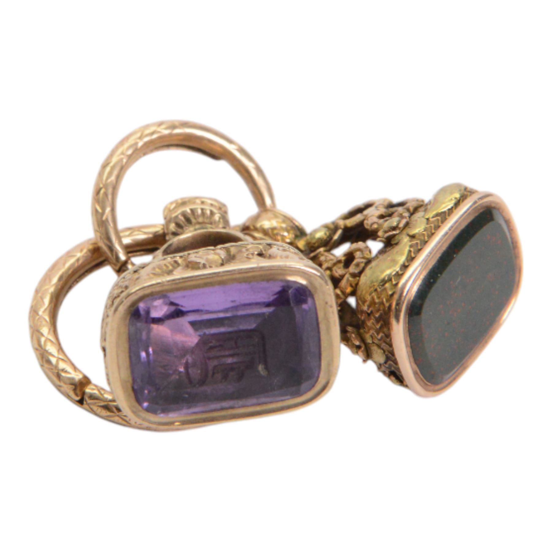 Two late 18th/early 19th century gold fob seals, the first 12ct example with amethyst matrix engraved with the letter D, the second 18ct example with bloodstone matrix, each within a foliate mount united by two 14ct ouroboros snake split rings, each seal approximately H2.5cm

Provenance: By family descent from the Chichesters of Arlington Court, Devon; from the collection of Andrew Chichester Everitt.