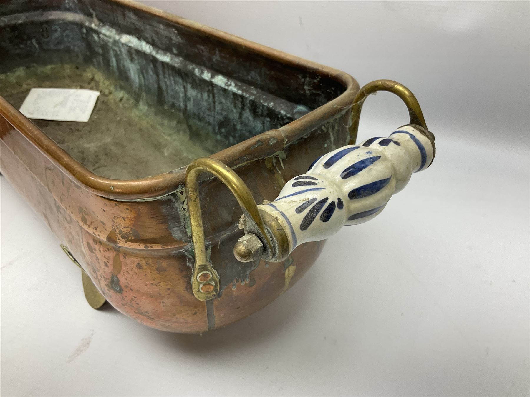 Copper planter of rectangular form with brass feet and twin handles, together with a brass mounted copper kettle, longest L54cm