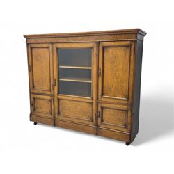 Late Victorian pollard oak bookcase or sideboard, the central glazed door opening to reveal adjustable shelves and interior makers label 