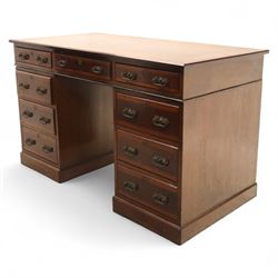 Early 20th century Indian hardwood pedestal desk, rectangular top with moulded edge over three frieze drawers, twin pedestals each fitted with four drawers, brass pierced swing handles and brass escutcheons, upon plinth bases  