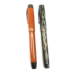 Two Vintage fountain pens, comprising Parker Duofold, with orange case, nib marked 14K, and a Waterman's Ideal, with chevron case and lever fill, nib marked 14K. (2). 