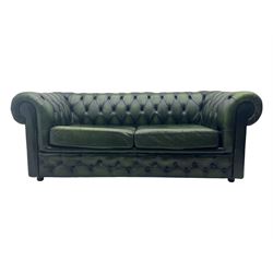 Two seat Chesterfield design sofa bed, upholstered in emerald green leather with deep-buttoned detailing, rolled arms, two loose seat cushions, and pull-out 