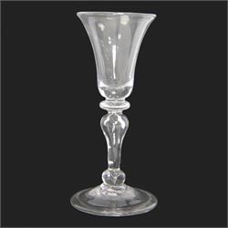 Mid 18th century wine glass, circa 1730-1740, with bell shaped bowl upon an inverted baluster stem with internal tear and basal knop, upon conical folded foot, H15cm