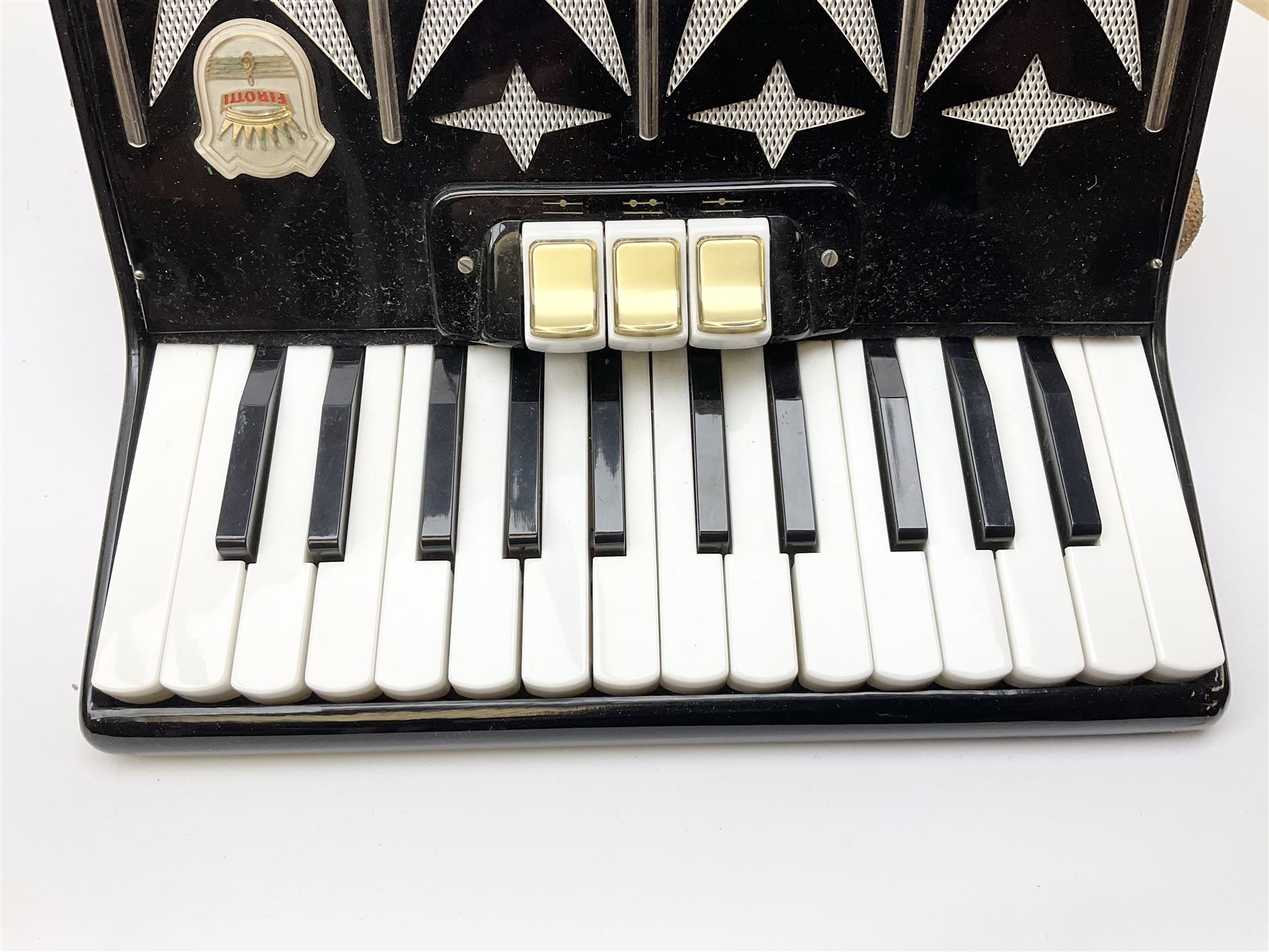 GDR Firotti piano accordion with black and silver case, sixteen keys and forty-eight buttons L38cm; in simulated reptile skin case with sheet music
