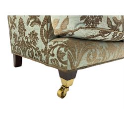 Wade - 'Kempston' three seat sofa, upholstered in chenille fabric with brocade pattern, raised on mahogany finish square tapering block feet with heavy brass castors