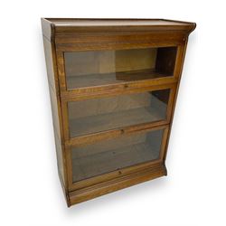 Early 20th century oak three-tier stacking library bookcase, enclosed by hinged and sliding glazed doors
