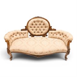 Victorian carved walnut framed double-ended settee with serpentine front, the central oval...
