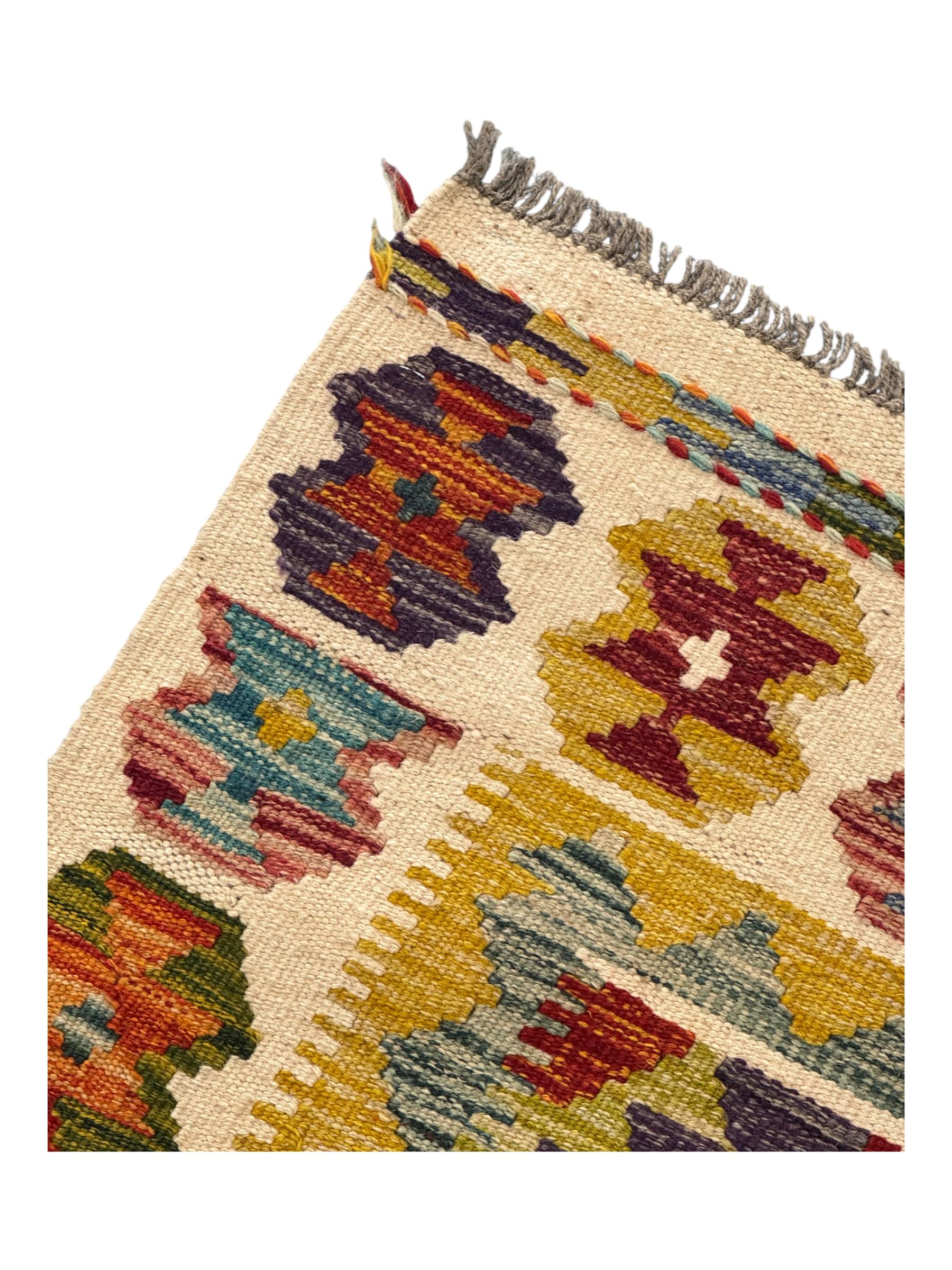 Chobi Kilim flatweave rug, cream ground with a multicoloured geometric diamond field, framed by a bold border of repeating stylised motifs, finished with braided corner tassels