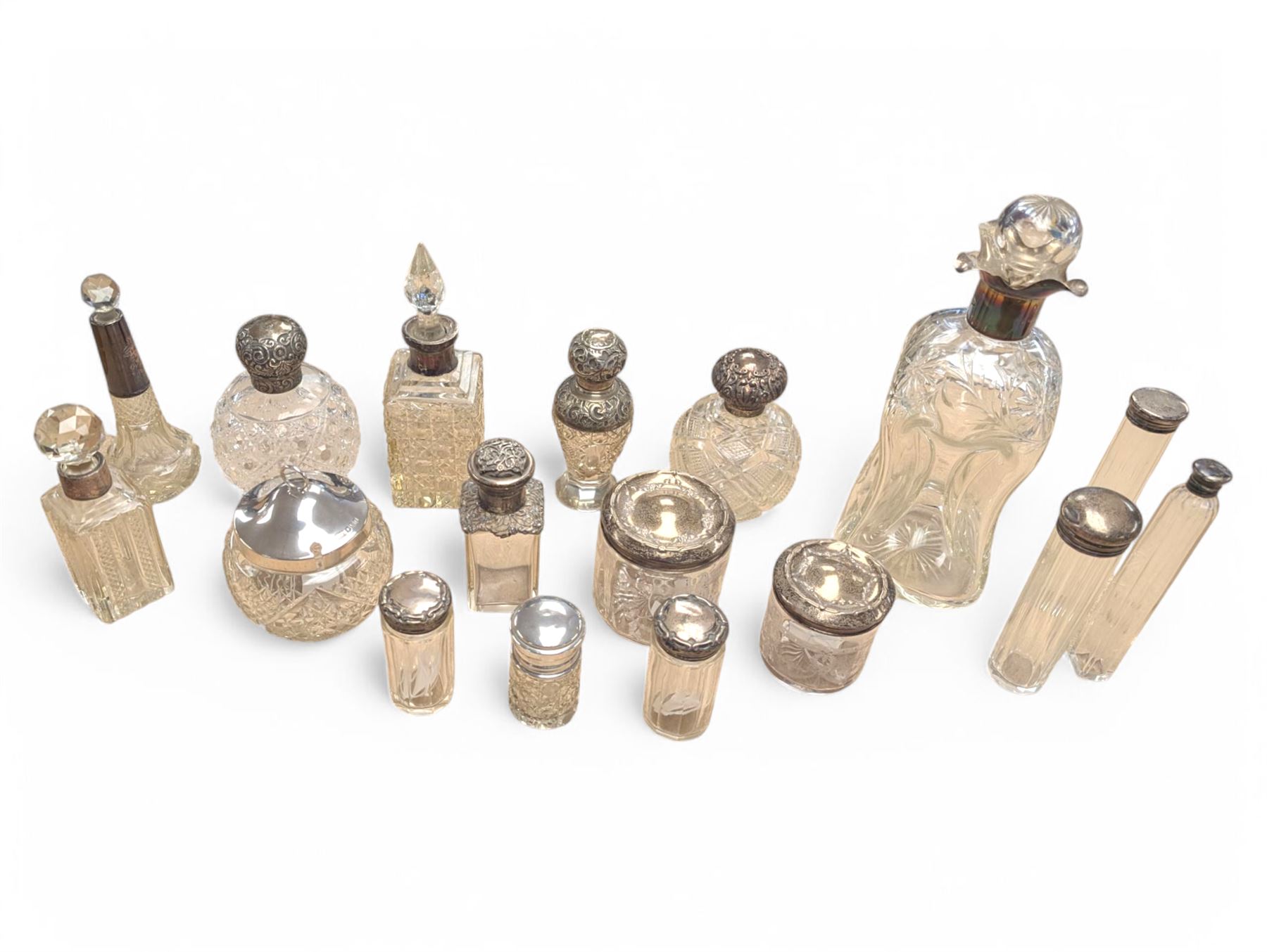 Collection of silver mounted glass bottles and jars, including decanter with etched floral decoration and silver collar, four scent bottles with silver caps, etc all hallmarked 