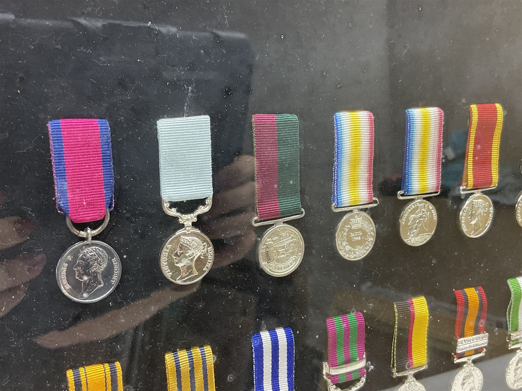 Limited edition large framed display board with sixty half-size copies of British Gallantry and Campaign Medals produced by Danbury Mint; all with ribbons and associated booklet