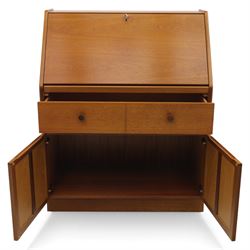 Parker Knoll - teak bureau, sloped fall front enclosing fitted interior, over two short drawers and two panelled cupboard doors