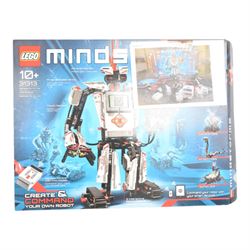 Two Lego Mindstorms sets, comprising 8547 NXT 2.0 and 31313 EV3, both partially built with boxes and instructions