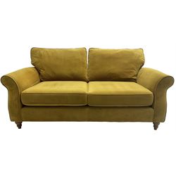 Next Furniture - traditional shaped three-seat sofa, upholstered in mustard velvet, rolled arms with pipping, on turned front feet