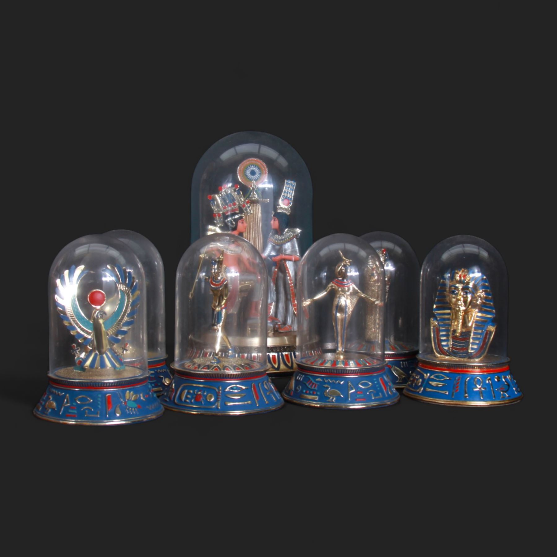 Franklin Mint seven Egyptian models under glass domes, including The Pharaoh and his Queen, The Mask of Tutankhamun, The Sacred Bast Cat, The Mighty Sun God Ra Harakhty etc, largest H22cm 