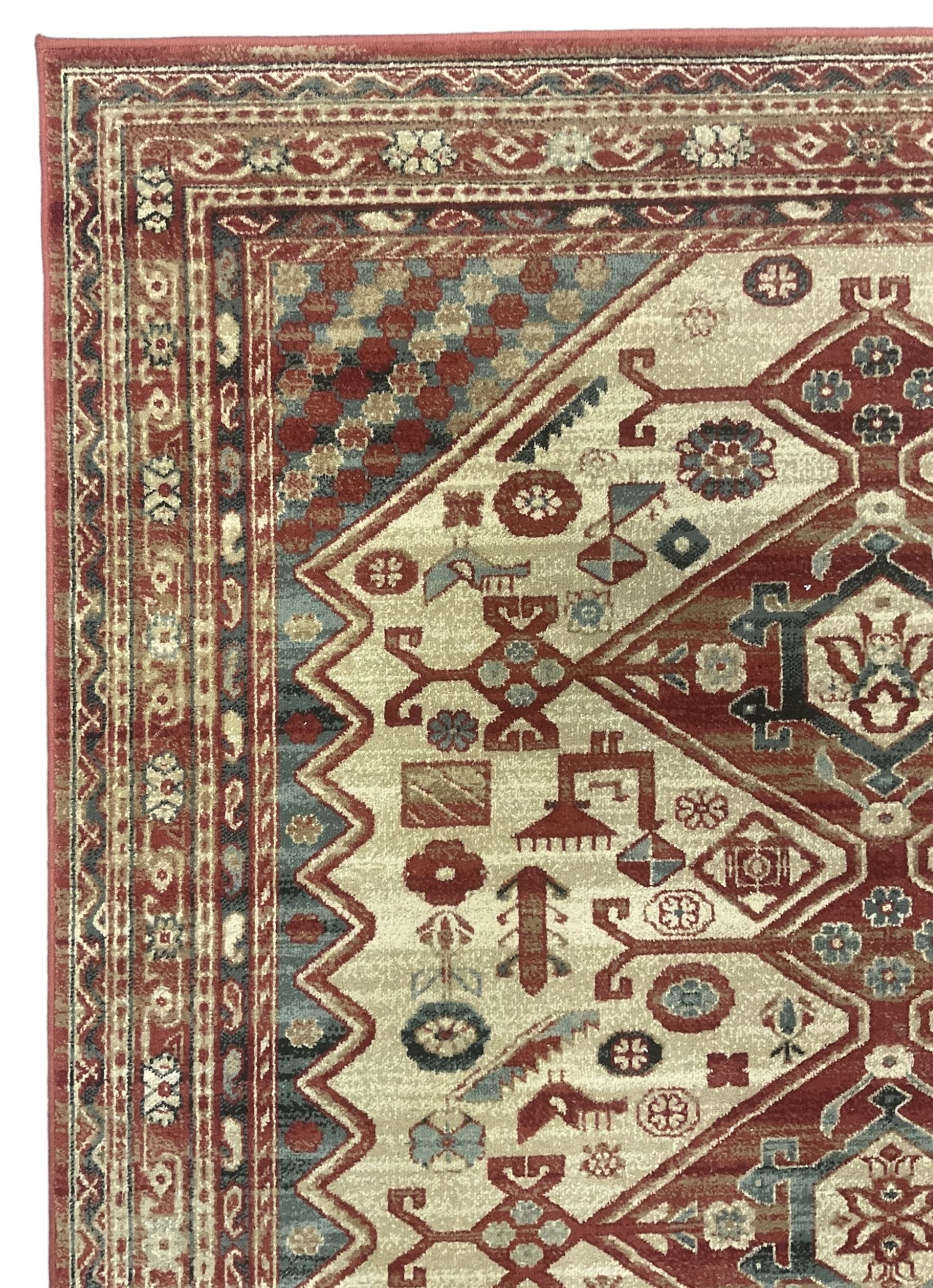 Persian design red ground rug, the field decorated with three interlinked lozenges and small stylised plant motifs, the multiple band border decorated with Boteh and floral motifs