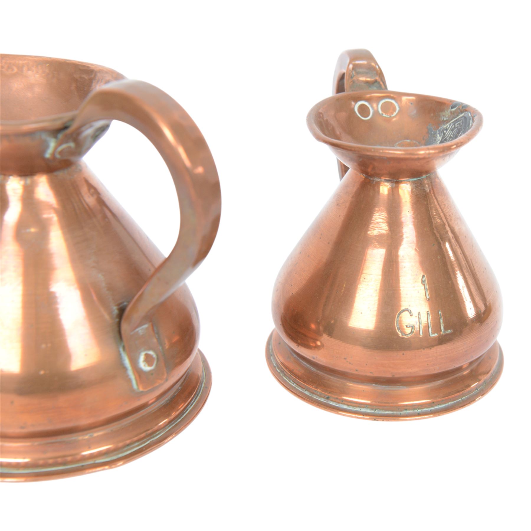 Copper and brass measures, including set of three copper jugs, set of four graduating brass pans and two sets of copper and brass cup measures
