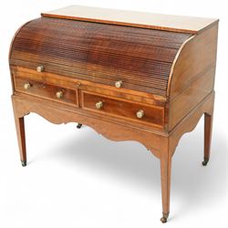 George III mahogany cylinder front writing desk, the hinged tambour enclosing pigeonholes and drawers with bone handles, sliding writing surface with leather inset, three frieze drawers below, on square tapering legs with brass caps and castors