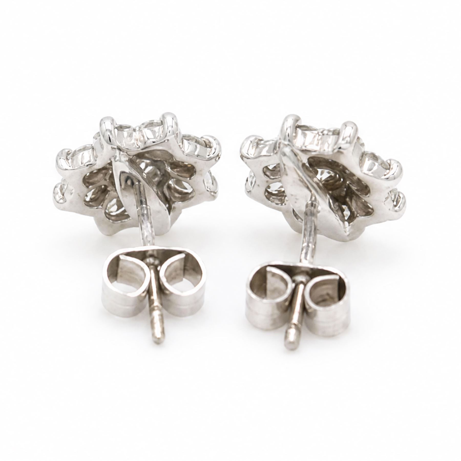 Pair of 18ct white gold diamond flower head earrings, each stud set with nine round brilliant cut diamonds, Birmingham 1996, total diamond weight approx 1.20 carat