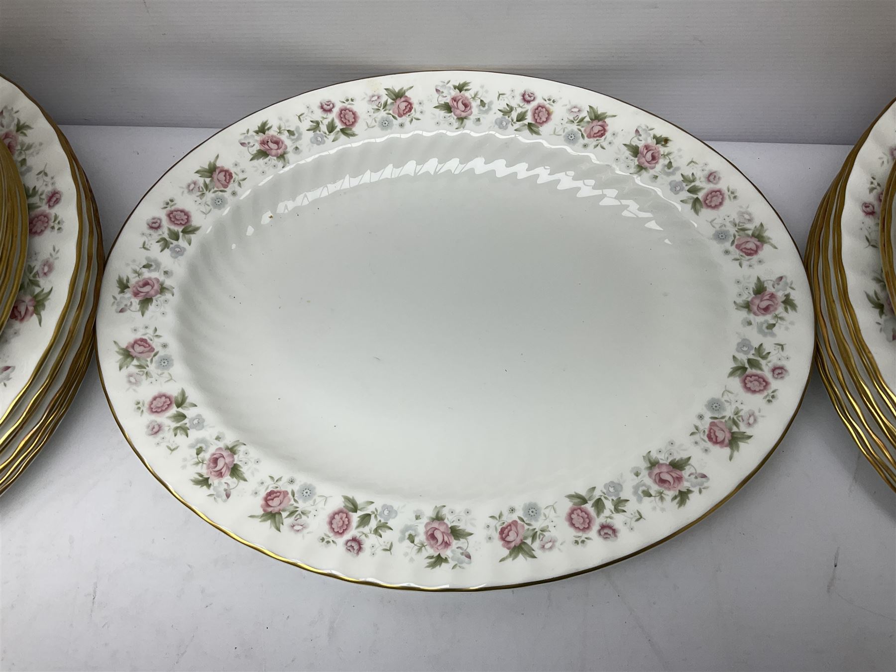 Minton Spring Bouquet pattern dinner and tea service, comprising dinner plates, twin handled tureens with covers, meat platter, teapot, milk jug, sugar bowl with cover, tea cups and saucers, bowls, cake plate, side plates, dessert plates, etc all with printed mark beneath (82)