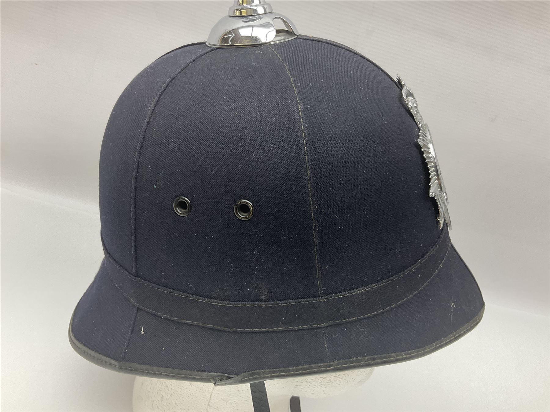 Police - Victorian turned hardwood truncheon with traces of decoration and VR cypher L42cm; Humberside Police helmet with Queens Crown helmet plate; hand lamp inscribed 'The Inspector'; and small pair of pewter figures of police officers (5)