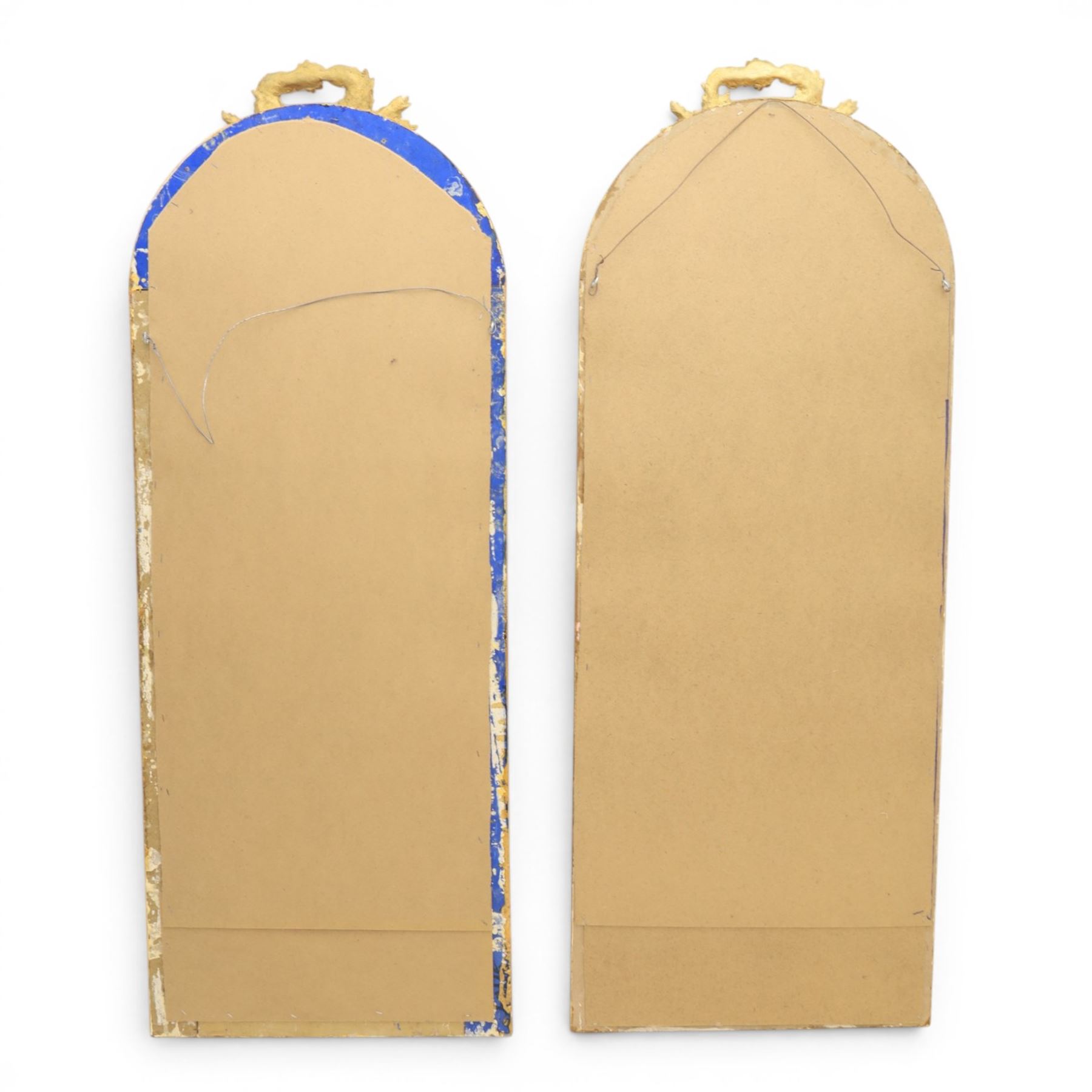 Louis XVI style giltwood pair of wall mirrors, arched frames with moulded borders, surmounted by ribbon tied floral crestings and trailing husk swags, enclosing bevelled mirror plates