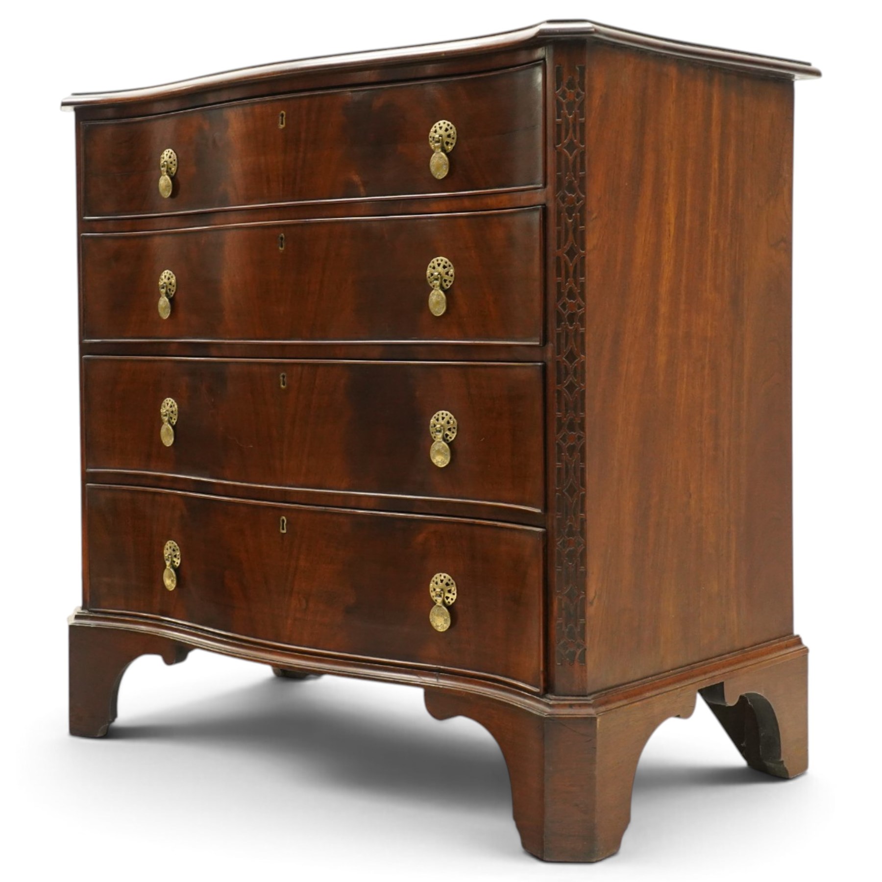 Quality Georgian design mahogany serpentine secretaire chest, the shaped top with moulded edge, fitted with cock-beaded secretaire drawer with button-release fall-front enclosing fitted interior, over three graduating drawers with brass drop handles on pierced circular plates, the canted uprights carved with blind-fret strapwork, lower moulded edge on shaped bracket feet