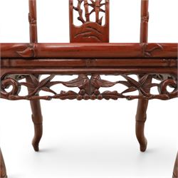 20th century Chinese ornately hardwood dining table and chairs, circular table with 'Lazy Susan' top with pierced carved frieze, raised on a quadriform base with carved foliate detail, the chairs en suite with carved pierced detailing  