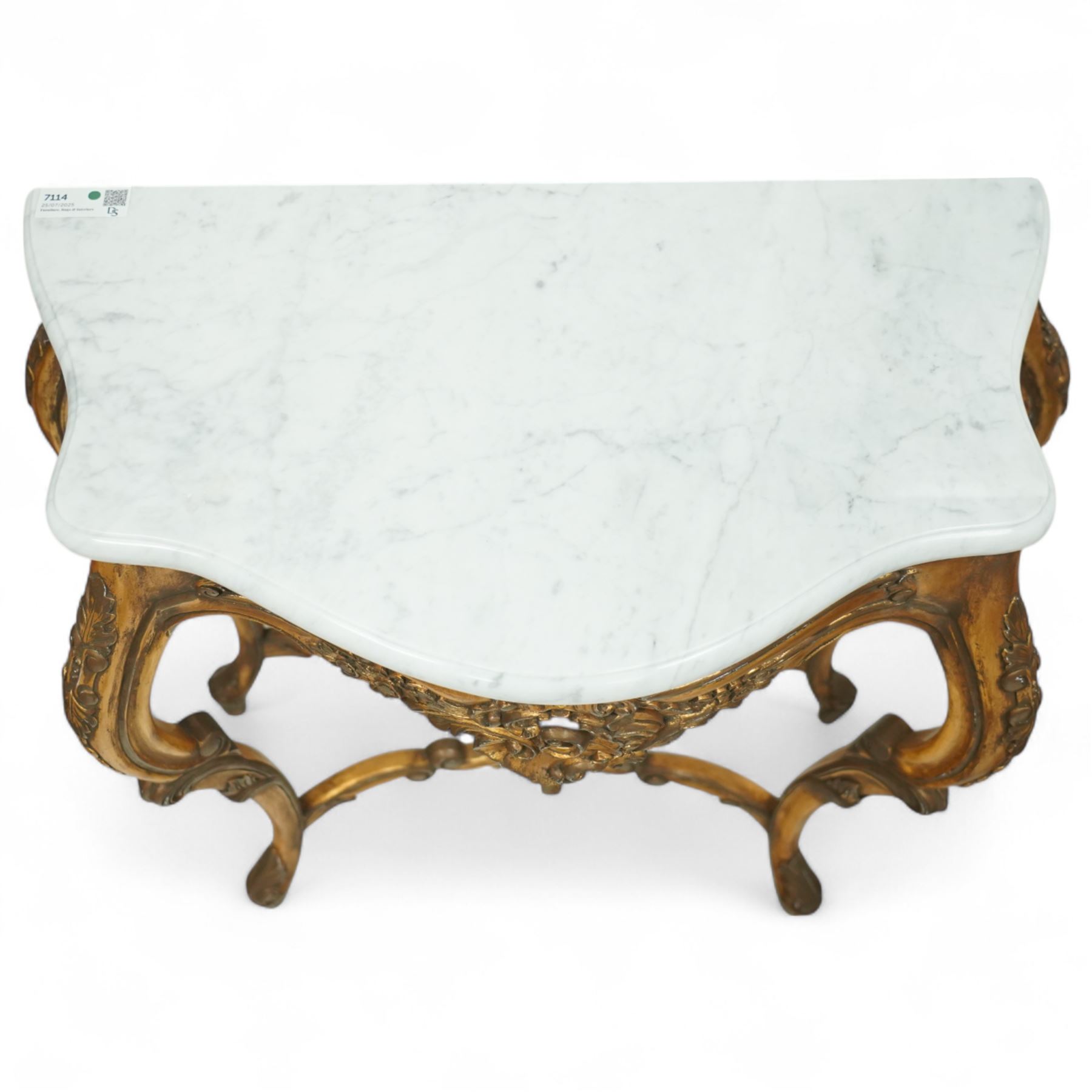 20th century Louis XV design giltwood console table, shaped white marble top over pierced and carved frieze with floral and foliate motifs, raised on cabriole supports united by X-shaped stretcher with central floral finial 