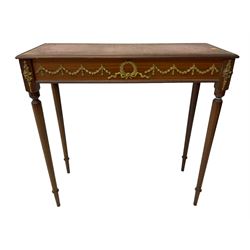 Early 20th century mahogany side table, inset amber leather surface, frieze decorated with applied gilt festoons and central wreath, on tapering fluted supports