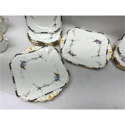 Art deco Shelley tea service for eight, decorated with floral sprigs, comprising teacup and saucers, dessert plates, two cake plates, milk jug and open sucrier, with to extra dessert plates